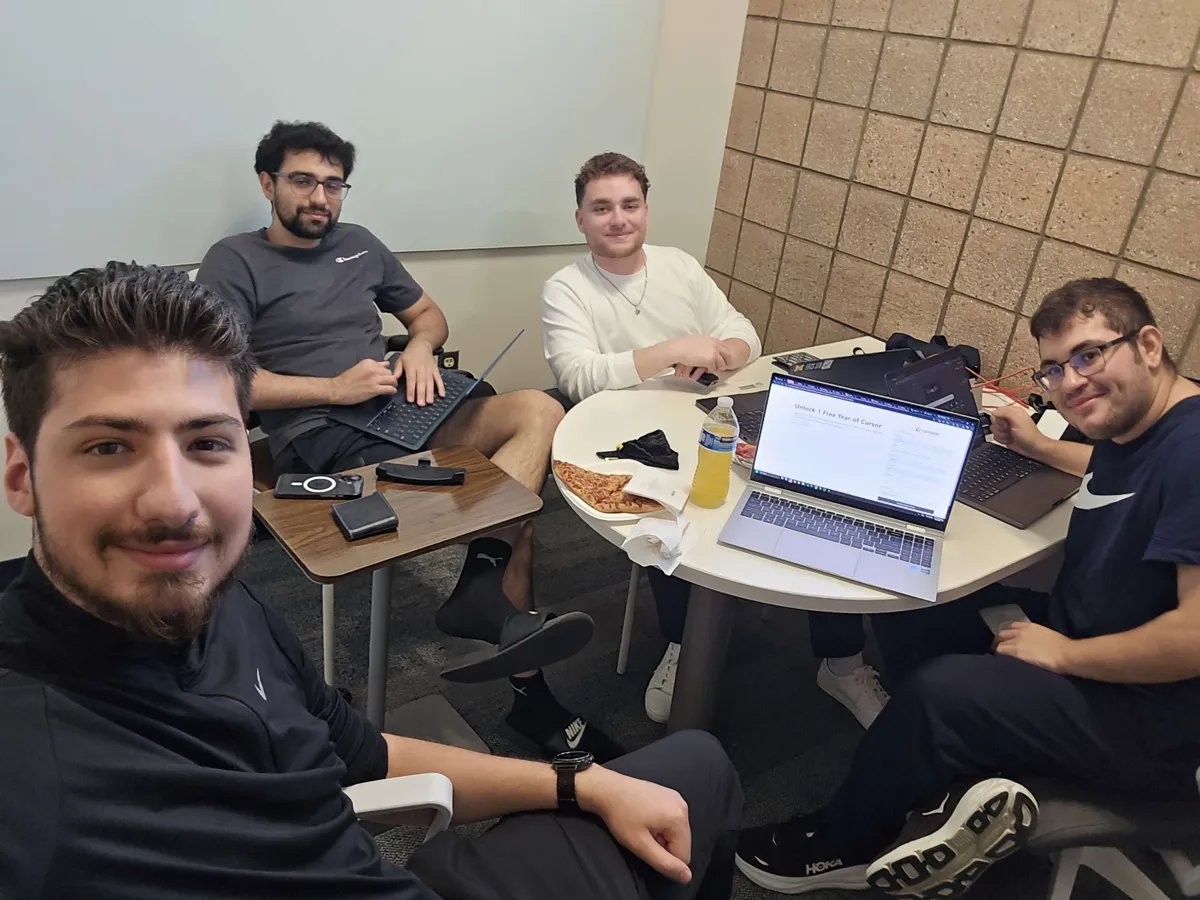 The Snap-Shot team of four working around a table at MHacks 2025